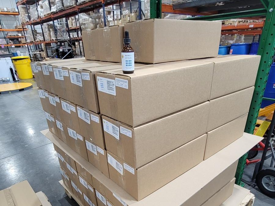 Pallet of boxed nano iodine bottles in a warehouse